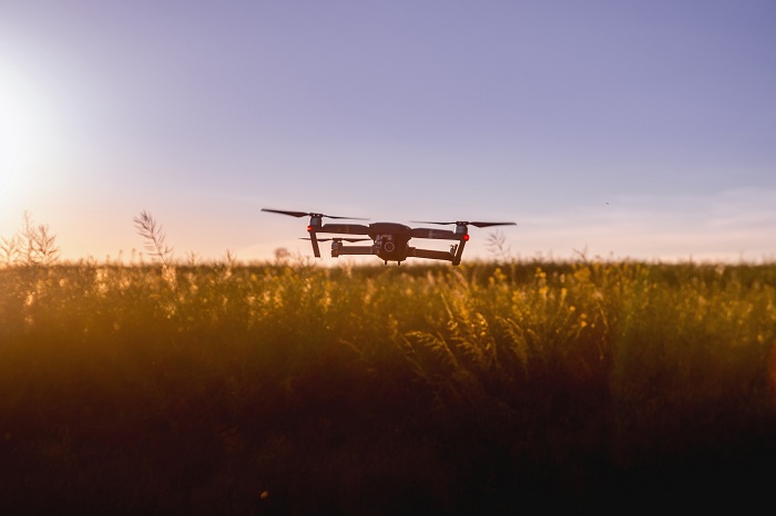 The dron flies over the field