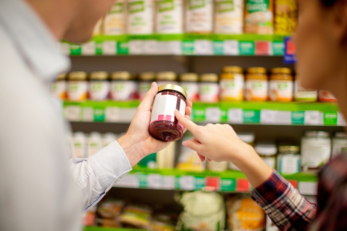 Couple choosing jar of jam